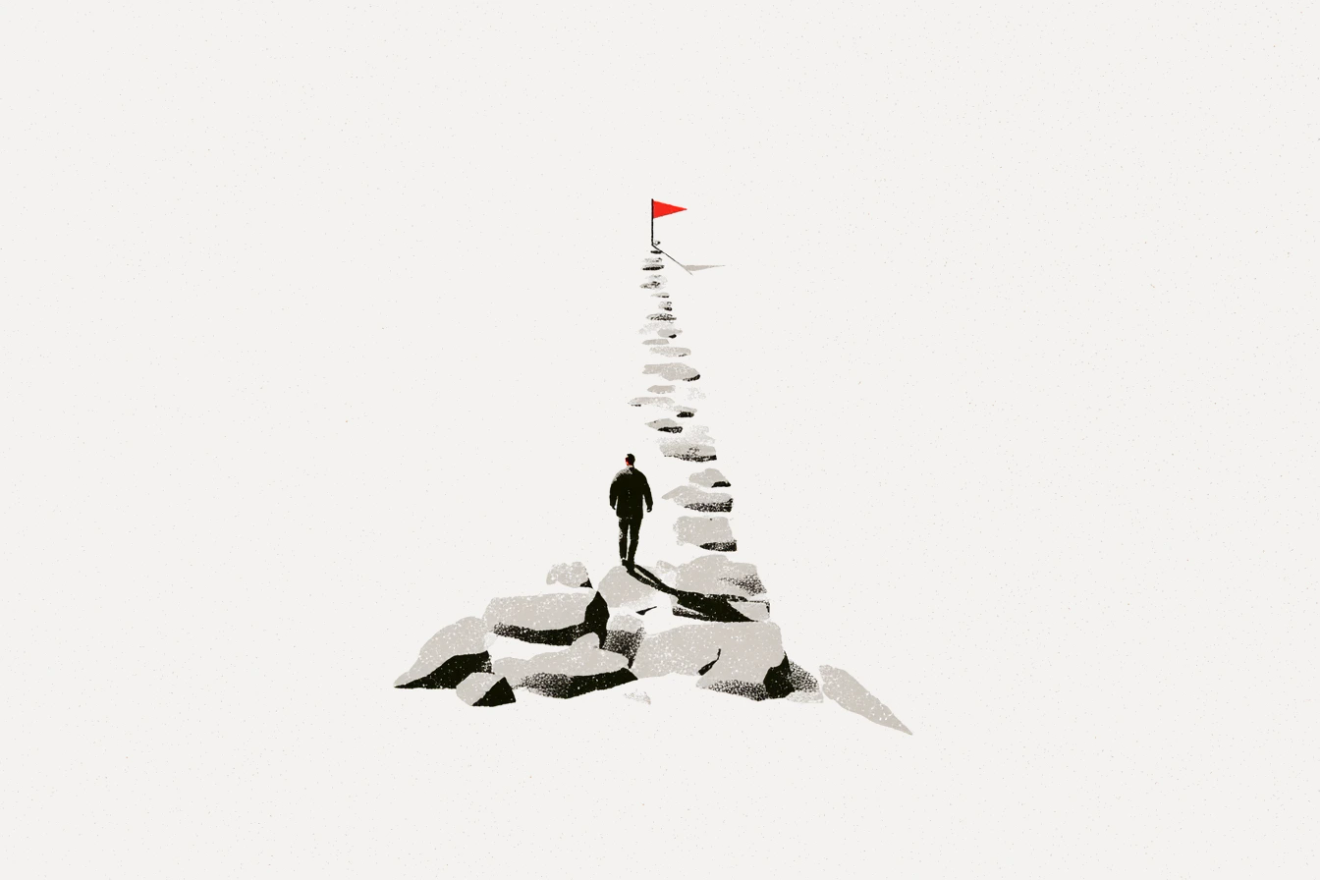 Illustration of a lone figure walking up a path of stepping stones that starts as a wide jumble of rocks and narrows to a single line ending at a small red flag